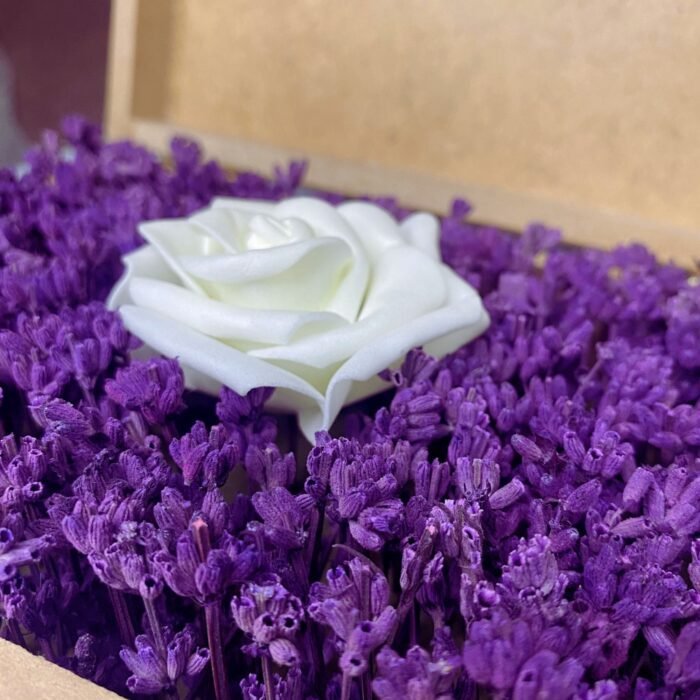 Close-up detail of a personalized wooden flower box filled with purple lavender and a single artificial white rose, highlighting the floral arrangement. Perfect for romantic gifts by Sear Handcrafted Elegance.
