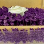 Close-up of a personalized wooden flower box filled with purple lavender and a single artificial white rose, showcasing intricate floral details. Ideal for romantic gifts or special occasions by Sear Handcrafted Elegance.