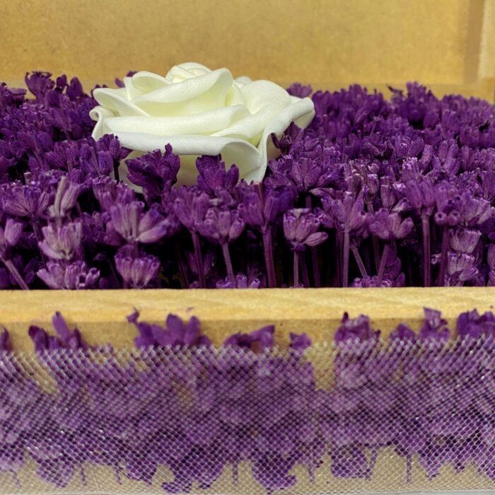 Close-up of a personalized wooden flower box filled with purple lavender and a single artificial white rose, showcasing intricate floral details. Ideal for romantic gifts or special occasions by Sear Handcrafted Elegance.
