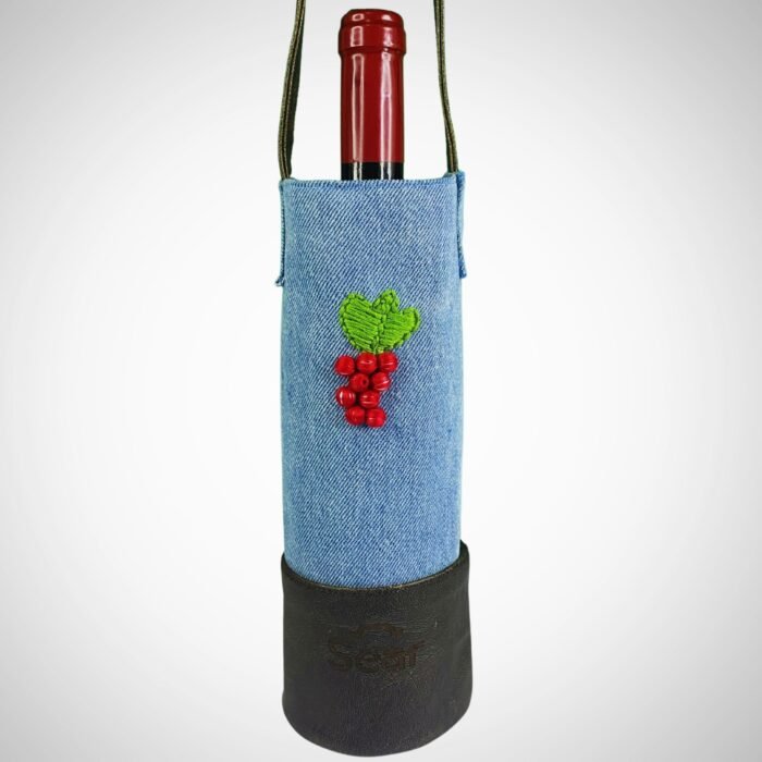 Front view of a handcrafted denim wine bag by Sear Handcrafted Elegance, holding a 750ml wine bottle. Features a leather strap, embroidered grapes, and a rustic leather base. Ideal for gifting wine lovers.