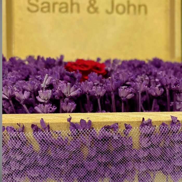 Front view of a personalized wooden flower box engraved with "Sarah & John," filled with purple lavender and a preserved red rose. A stunning romantic gift by Sear Handcrafted Elegance.