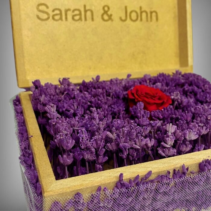 Full view of a personalized wooden flower box engraved with "Sarah & John," featuring purple lavender and a preserved red rose. A perfect romantic gift or keepsake by Sear Handcrafted Elegance.