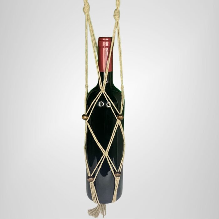 A Sear Handcrafted Elegance macrame wine bottle bag in brown, handmade from 100% recycled cotton, holding a wine bottle. The bag features an intricate knot design with brown decorative beads and a tassel at the bottom, displayed against a plain background.