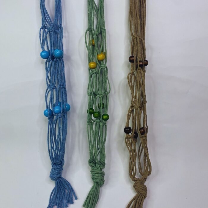 Three Sear Handcrafted Elegance macrame wine bottle bags, handmade from 100% recycled cotton, in blue, green, and beige. Each bag features an intricate knot design with decorative beads in blue, green, and brown, hanging against a plain background.