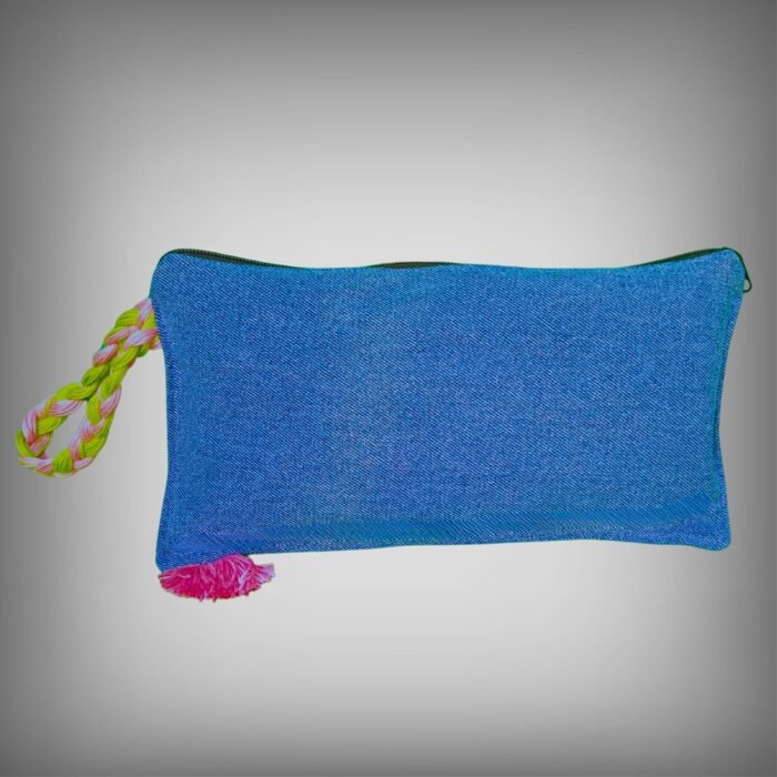 Back view of a blue denim makeup bag by Sear Handcrafted Elegance, highlighting its clean design with a pink and green braided strap and a pink tassel detail. A versatile and durable cosmetic pouch for everyday use.