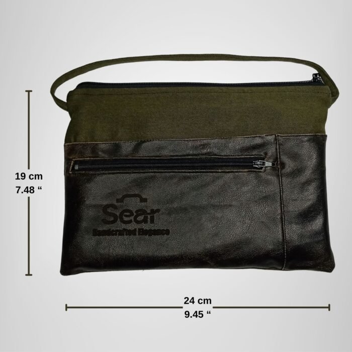 Green and black leather handbag by Sear Handcrafted Elegance, front view, with dimensions: 24 cm (9.45 inches) wide and 19 cm (7.48 inches) tall. Features a front pocket and modern design.