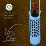 Blue handmade crochet wine bottle bag, made from certified organic cotton. Elegant and eco-friendly design, perfect for gifting wine.