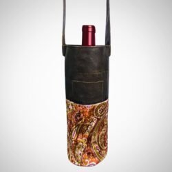 Handmade leather paisley wine bag with leather strap by Sear Handcrafted Elegance, holding a wine bottle.