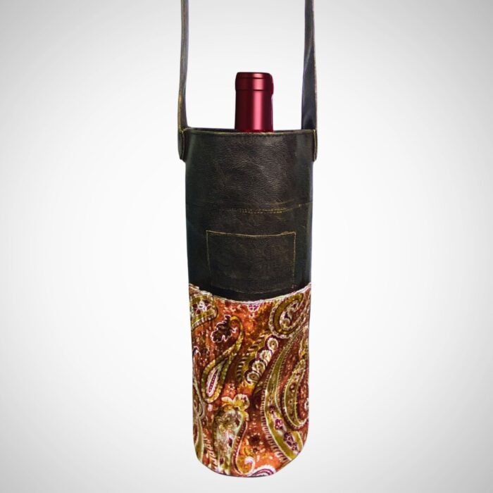 Handmade leather paisley wine bag with leather strap by Sear Handcrafted Elegance, holding a wine bottle.