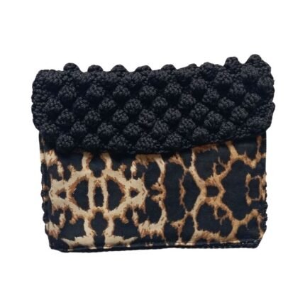 A stylish clutch bag from Sear Handcrafted Elegance featuring a bold leopard print pattern on the lower half and a textured black knitted design on the upper half, perfect for adding a touch of sophistication to any outfit.
